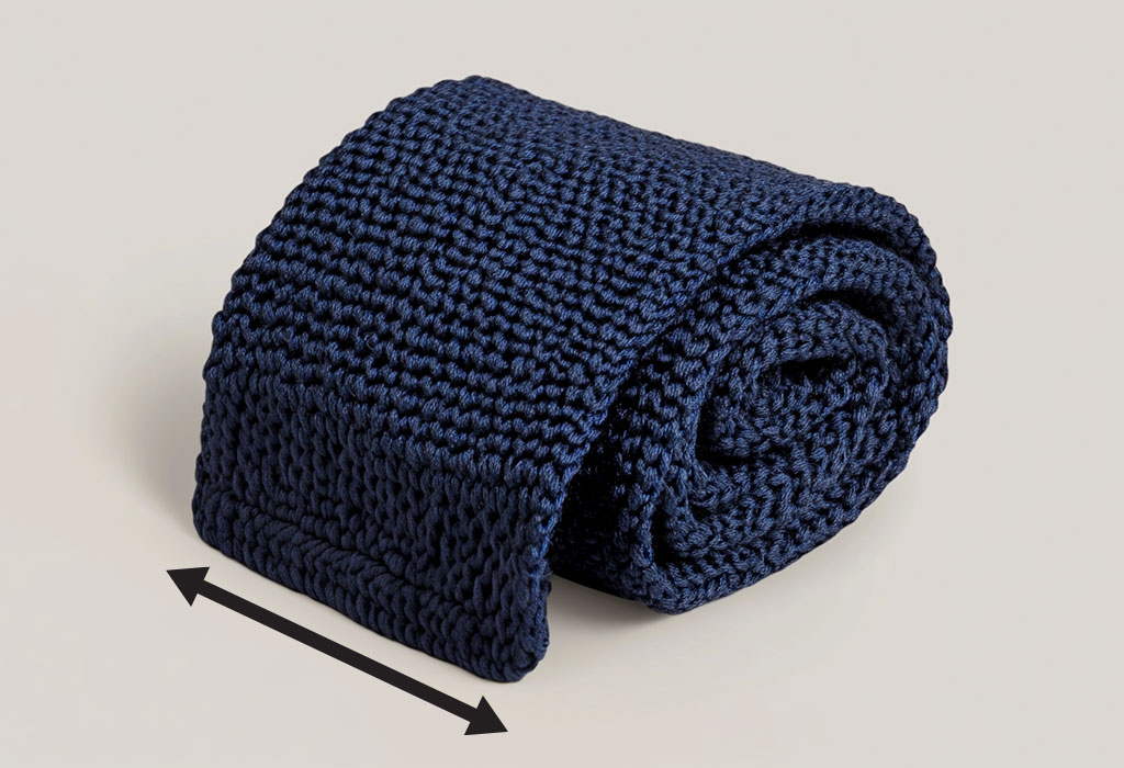 squared end knit tie being measured